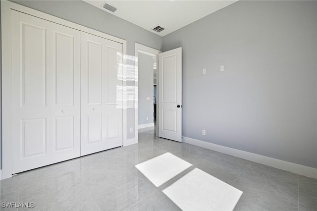 1042 Bassinger Ave S, Lehigh Acres, FL 33974 - unfurnished bedroom with visible vents, baseboards, and a closet
