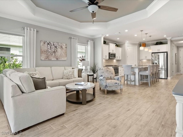 2138 Marquesa Cir, Naples, FL 34112 - living room with a raised ceiling, ceiling fan, ornamental molding, recessed lighting, and light wood finished floors