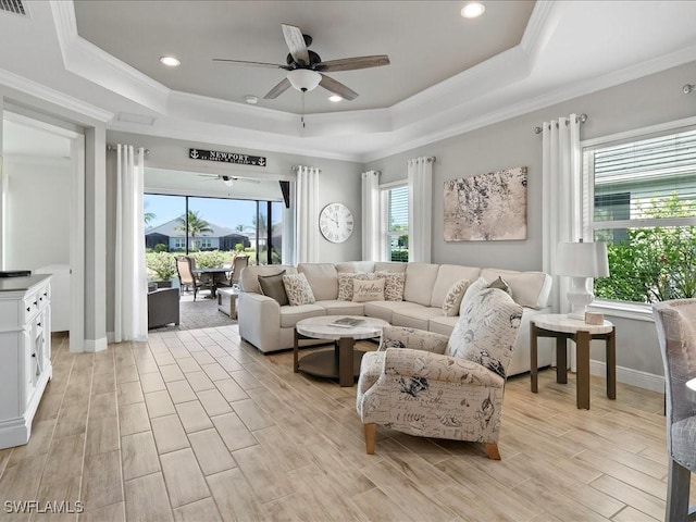 2138 Marquesa Cir, Naples, FL 34112 - living area with a raised ceiling, ceiling fan, crown molding, light wood-style floors, and baseboards