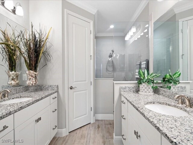 2138 Marquesa Cir, Naples, FL 34112 - bathroom featuring two vanities, crown molding, walk in shower, baseboards, and recessed lighting