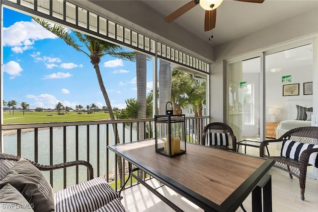 sunroom / solarium with a water view and wood finished floors