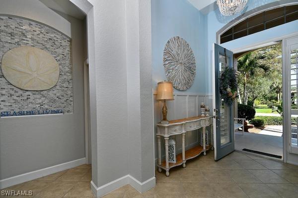 tiled entryway with an inviting chandelier