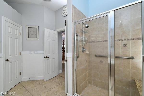 bathroom featuring a stall shower, visible vents, and tile patterned floors