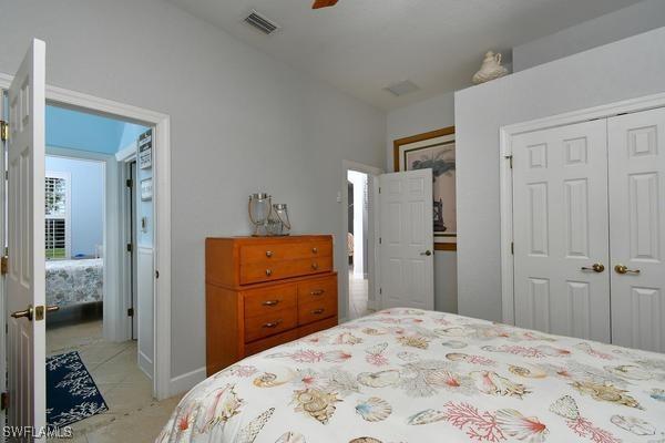 bedroom with visible vents, a closet, and ceiling fan