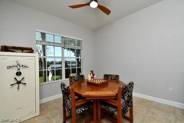 dining area featuring ceiling fan and baseboards