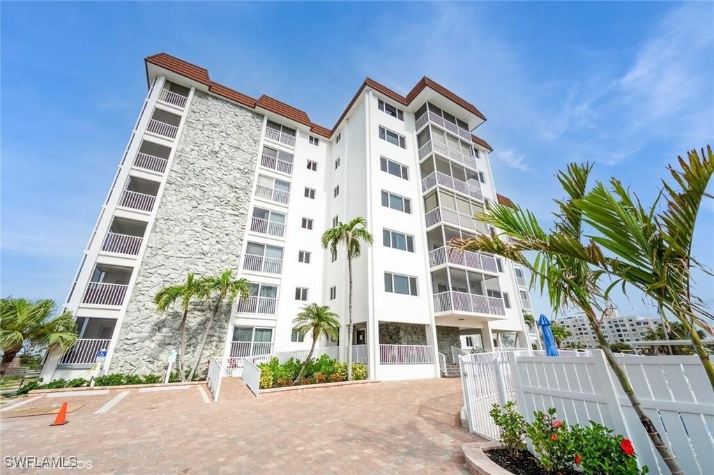 6900 Estero Blvd Unit 509, Fort Myers Beach, FL 33931 - view of apartment building / complex featuring fence