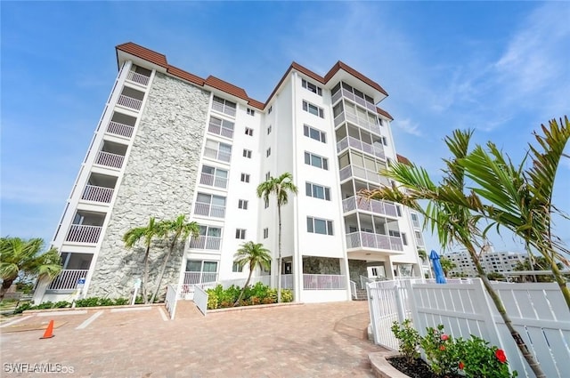 view of apartment building / complex featuring fence