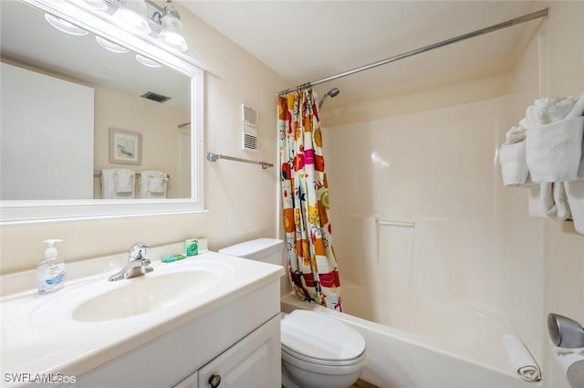 bathroom with toilet, shower / bath combo with shower curtain, and vanity