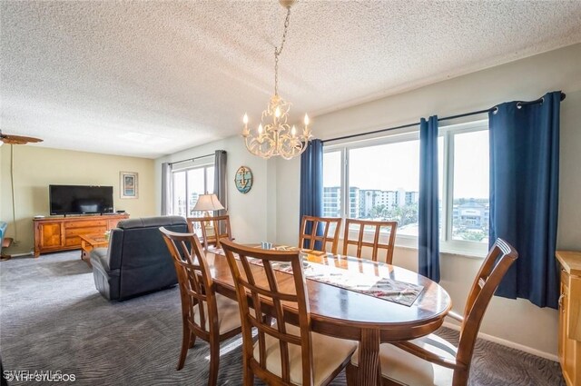 dining area with a textured ceiling, carpet flooring, and a chandelier