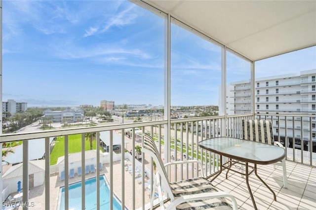 balcony with a view of city and view of pool area