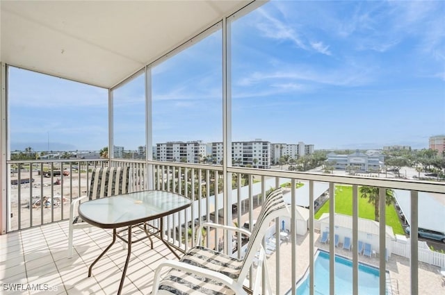 balcony with a view of city and view of pool area