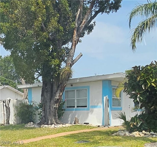 2631 Becca Ave, Naples, FL 34112 - view of front facade featuring a front lawn, fence, and stucco siding