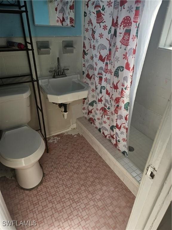 2631 Becca Ave, Naples, FL 34112 - full bathroom featuring a shower stall, tile patterned flooring, a sink, and toilet