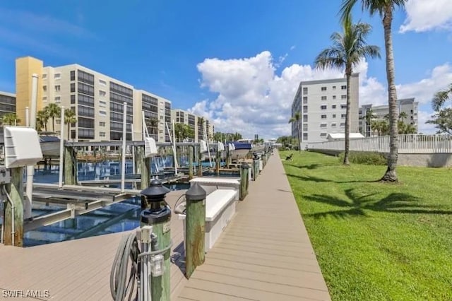 4361 Bay Beach Ln Unit 224, Fort Myers Beach, FL 33931 - dock area featuring a lawn
