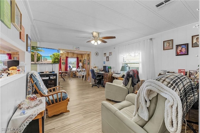 living room with visible vents, a ceiling fan, and wood finished floors