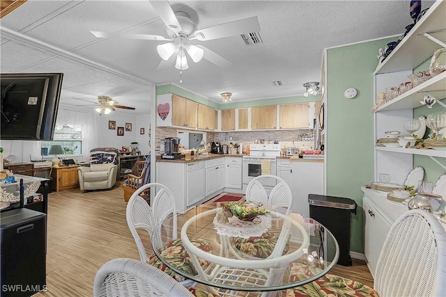 dining space with visible vents, ceiling fan, and light wood finished floors