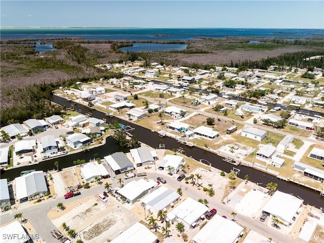 drone / aerial view with a residential view and a water view