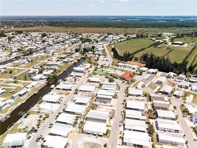 birds eye view of property with a water view and a residential view
