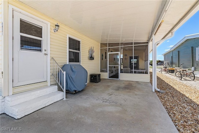 view of patio / terrace featuring entry steps, grilling area, and a sunroom