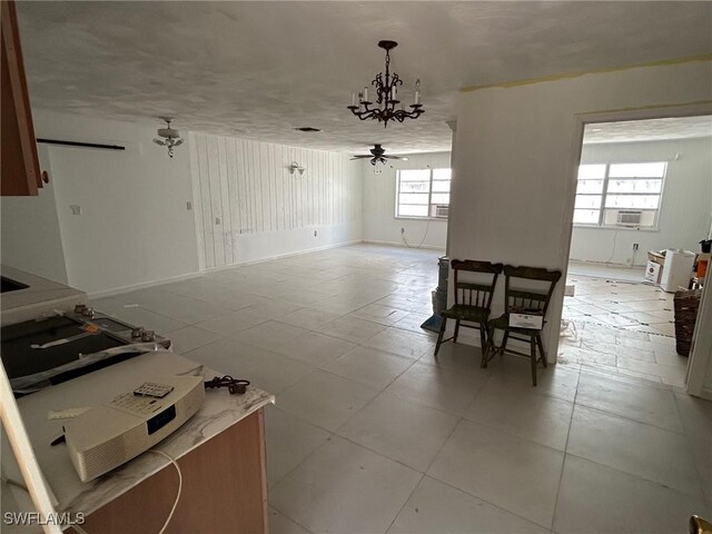 356 3rd Ave, Marco Island, FL 34145 - dining area with cooling unit and ceiling fan with notable chandelier