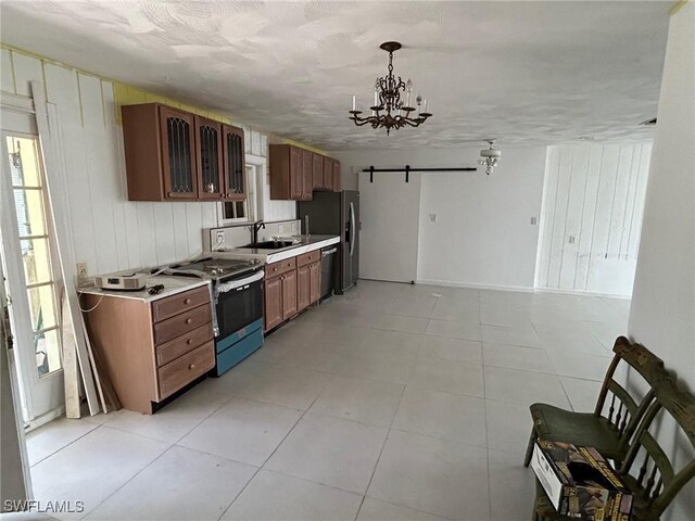 356 3rd Ave, Marco Island, FL 34145 - kitchen with a barn door, a healthy amount of sunlight, appliances with stainless steel finishes, and a sink