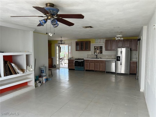 356 3rd Ave, Marco Island, FL 34145 - kitchen with visible vents, a sink, ceiling fan with notable chandelier, light countertops, and appliances with stainless steel finishes