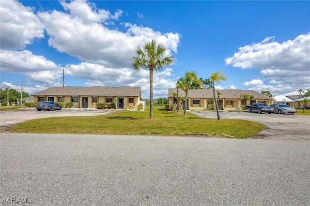 26136 Explorer Rd, Punta Gorda, FL 33983 - ranch-style home featuring a front lawn