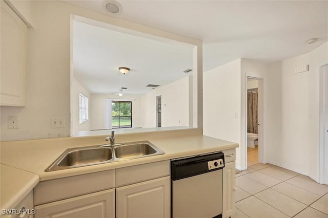 26136 Explorer Rd, Punta Gorda, FL 33983 - kitchen with dishwasher, a sink, light countertops, and light tile patterned floors