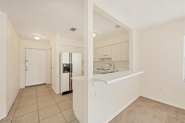 26136 Explorer Rd, Punta Gorda, FL 33983 - kitchen featuring white appliances, under cabinet range hood, white cabinets, light countertops, and baseboards