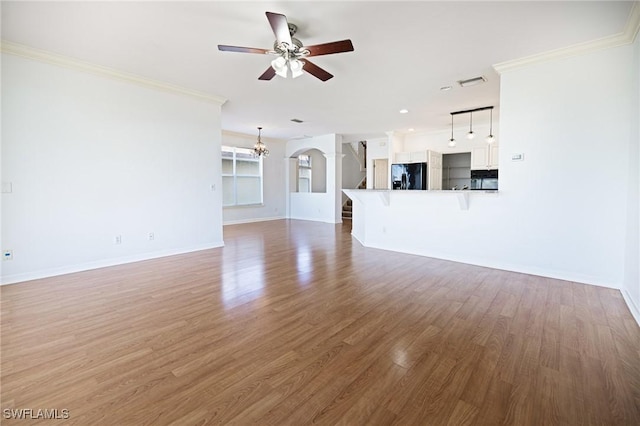 6081 Waterway Bay Dr, Fort Myers, FL 33908 - unfurnished living room with crown molding, baseboards, and ceiling fan with notable chandelier