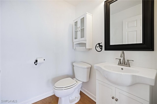 6081 Waterway Bay Dr, Fort Myers, FL 33908 - bathroom with wood finished floors, vanity, toilet, and baseboards