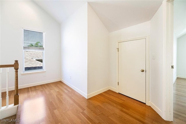 6081 Waterway Bay Dr, Fort Myers, FL 33908 - unfurnished room featuring lofted ceiling, light wood finished floors, and baseboards