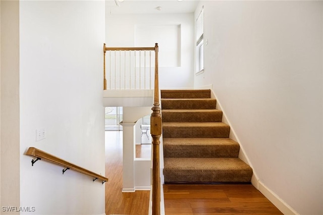 6081 Waterway Bay Dr, Fort Myers, FL 33908 - stairs featuring plenty of natural light, baseboards, and wood finished floors
