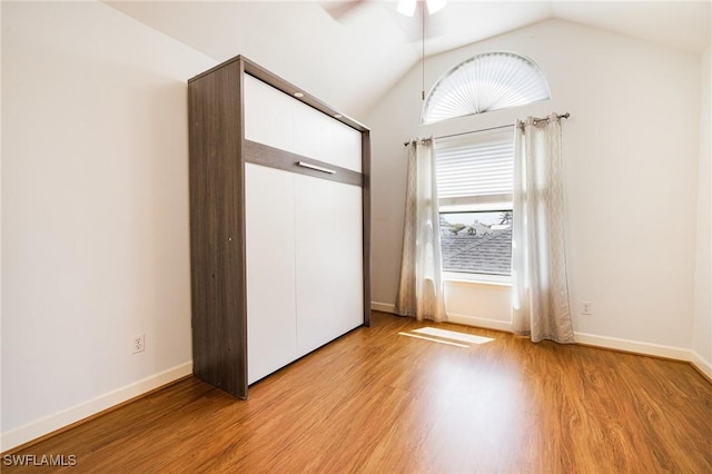 6081 Waterway Bay Dr, Fort Myers, FL 33908 - unfurnished bedroom featuring vaulted ceiling, light wood-style flooring, a closet, and baseboards