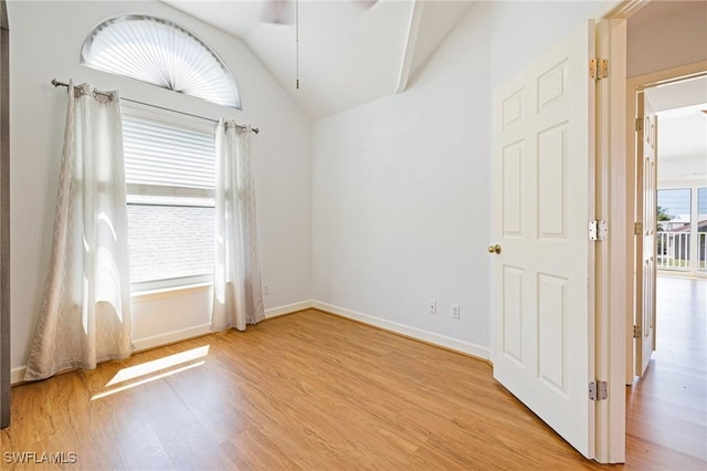 6081 Waterway Bay Dr, Fort Myers, FL 33908 - empty room with baseboards, lofted ceiling, a ceiling fan, and light wood-type flooring