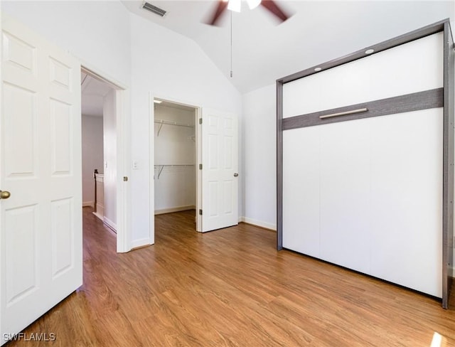 6081 Waterway Bay Dr, Fort Myers, FL 33908 - unfurnished bedroom featuring lofted ceiling, a spacious closet, visible vents, light wood-style floors, and ceiling fan