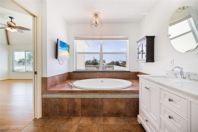 6081 Waterway Bay Dr, Fort Myers, FL 33908 - full bathroom with a garden tub, vanity, and ceiling fan