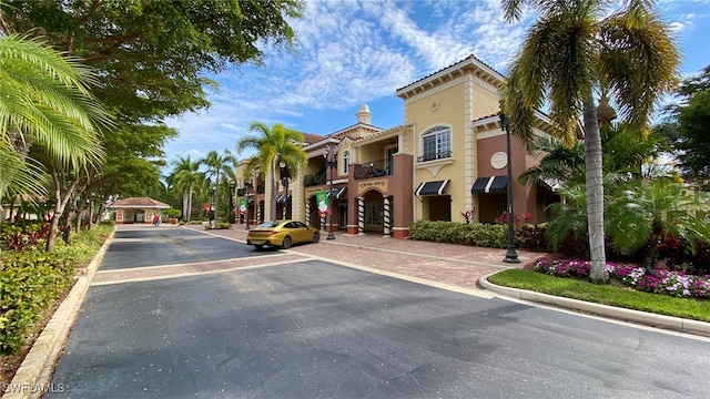 view of street with curbs, sidewalks, and street lights