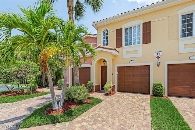 mediterranean / spanish house with stucco siding, driveway, and an attached garage