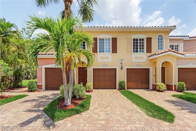 20251 Royal Villagio Ct Unit 201, Estero, FL 33928 - mediterranean / spanish home featuring stucco siding, driveway, and a tile roof