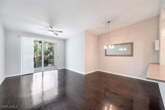unfurnished room with baseboards, wood finished floors, and ceiling fan with notable chandelier