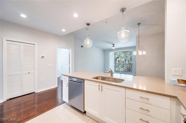 kitchen featuring a sink, a ceiling fan, white cabinetry, hanging light fixtures, and dishwasher