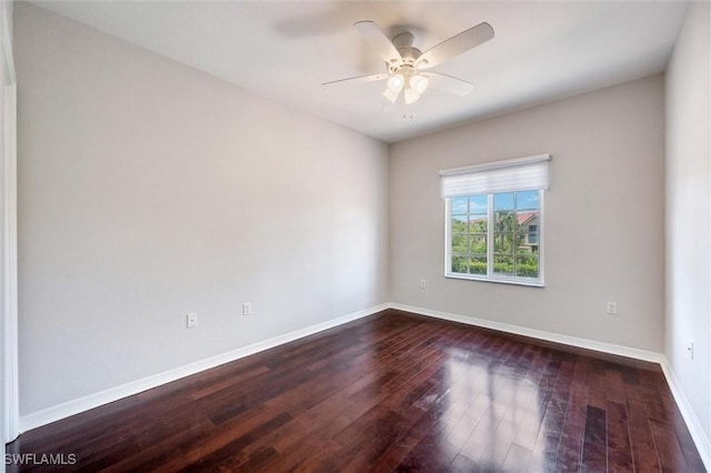 unfurnished room with ceiling fan, baseboards, and dark wood-type flooring