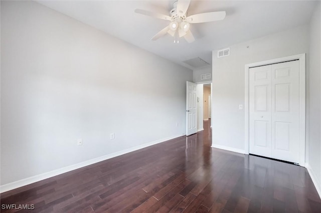 unfurnished bedroom featuring visible vents, baseboards, and dark wood-type flooring