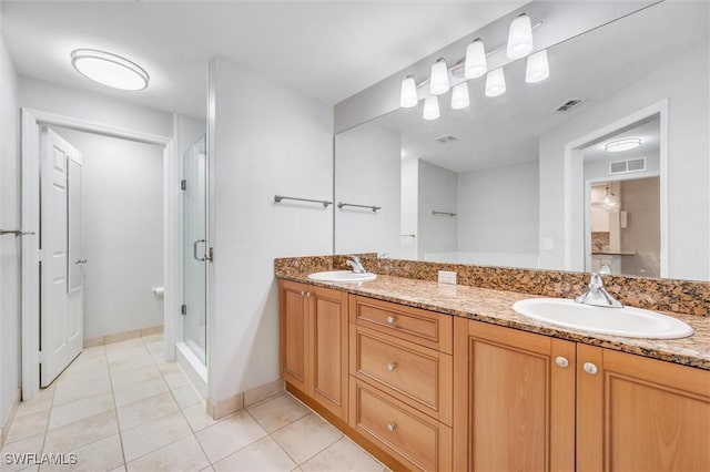 bathroom with a sink, a shower stall, and visible vents