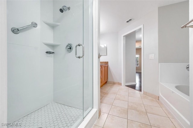 full bath featuring a shower stall, visible vents, tile patterned floors, a garden tub, and vanity
