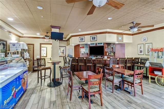 dining room featuring crown molding, recessed lighting, a ceiling fan, and wood finished floors