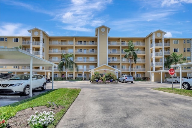 view of property with covered and uncovered parking
