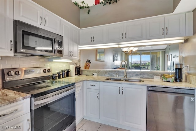 kitchen with a sink, white cabinetry, and stainless steel appliances