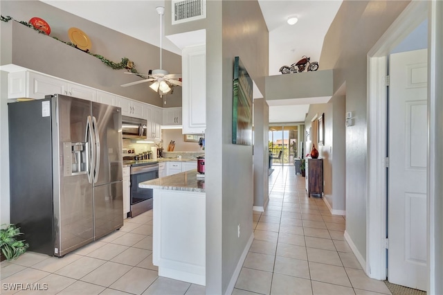 kitchen featuring light tile patterned floors, white cabinets, visible vents, ceiling fan, and appliances with stainless steel finishes